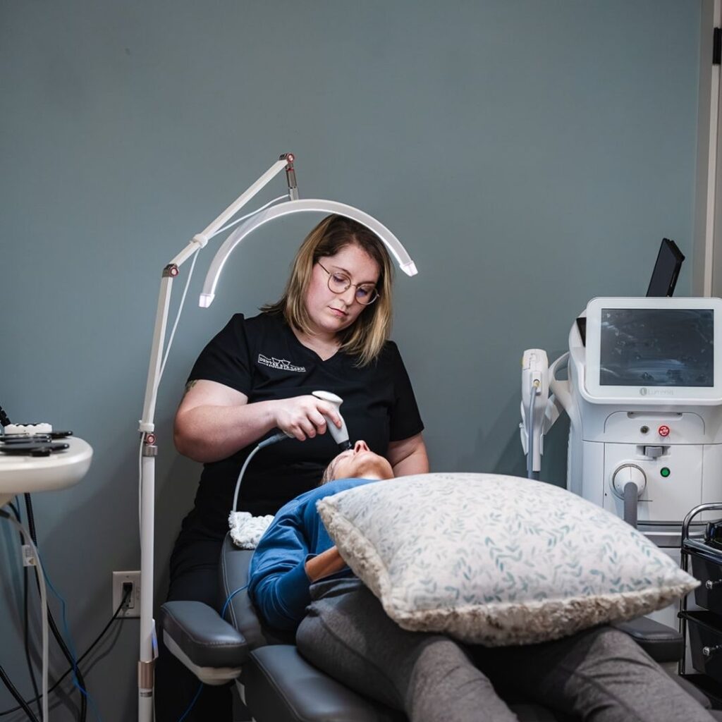 An eye doctor performing a treatment on a woman