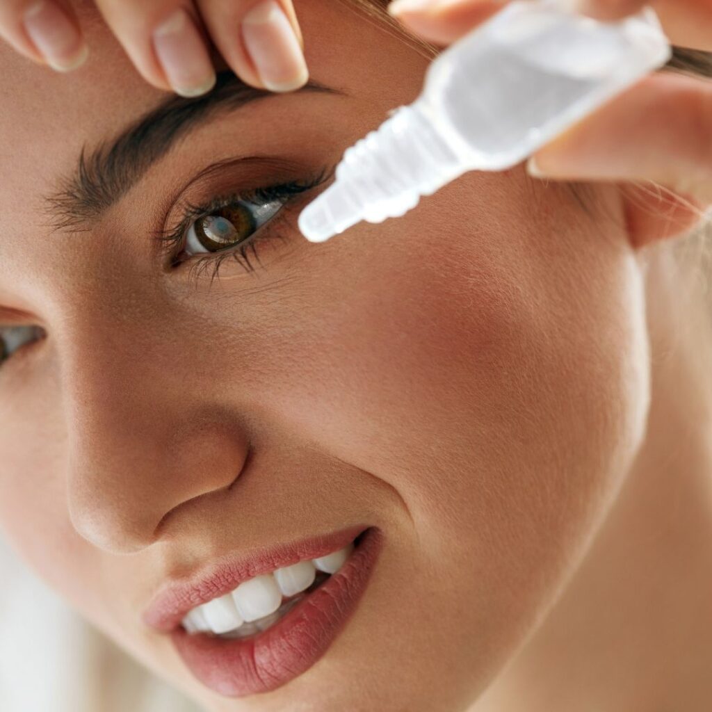 A woman using eye drops