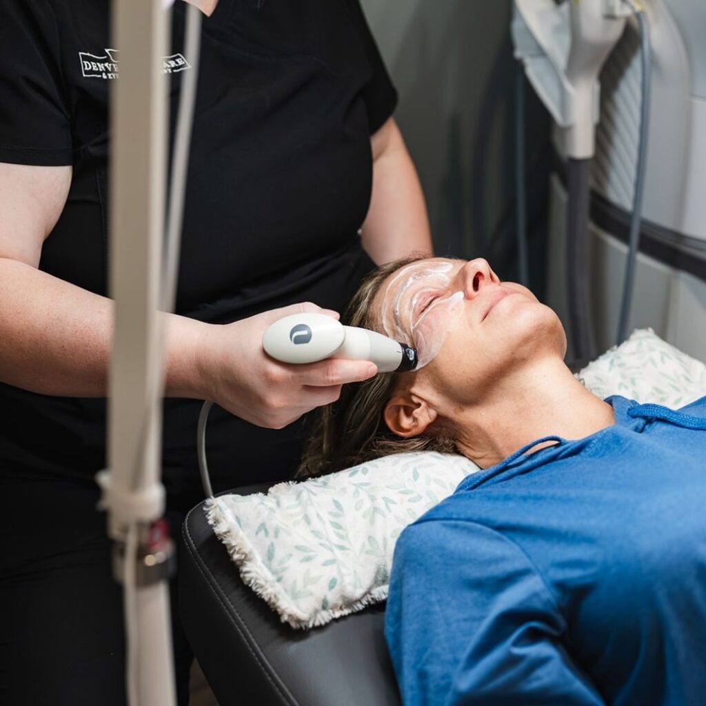 optometrist using a tool on a patients face