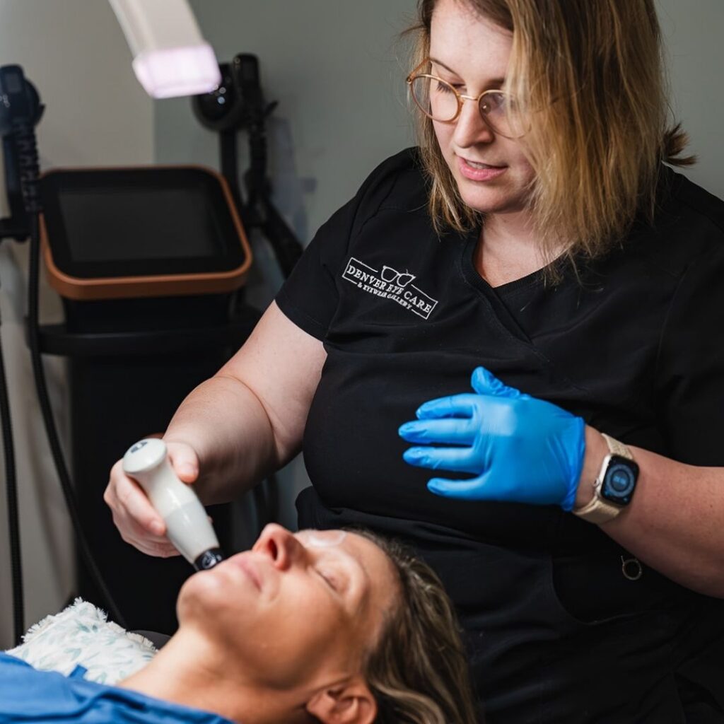 optometrist using a tool on a patient's face