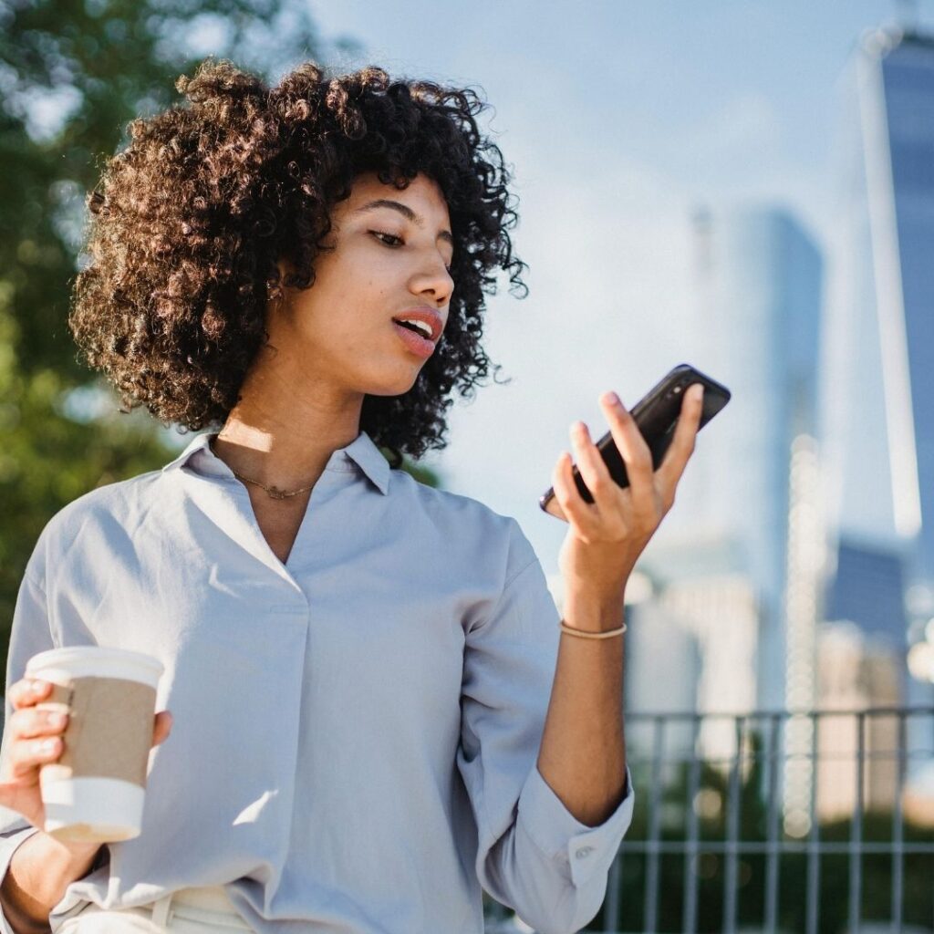 woman holding phone away from face